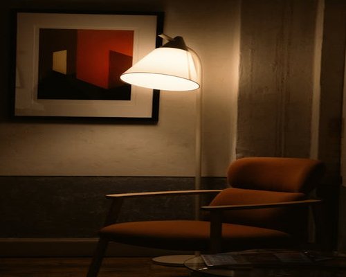 A cozy reading nook illuminated by a warm standing lamp during the evening